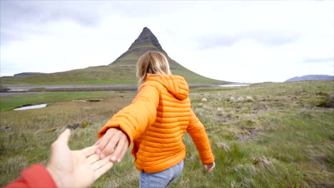 Follow-me-to-nature,-girlfriend-leading-man-to-Kirkjufell-mountain