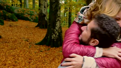 young-woman-running-and-hugging-his-boyfriend-in-fall-park