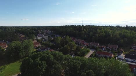 Aerial-view-over-neighborhood-houses-and-forest.-Flying-over-residential-suburb-area