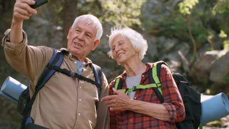 Glücklich-Senioren-nehmen-Selfie-im-Wald
