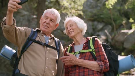 Happy-Seniors-Taking-Selfie-in-Forest