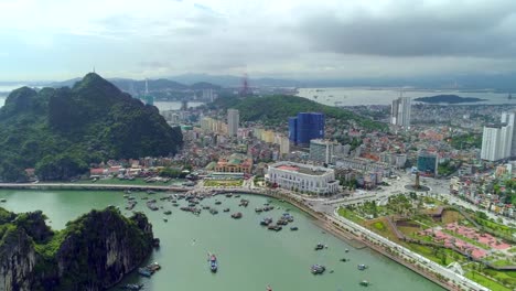 4k-Aerial-view-over-city-and-park-with-Bai-Tho-karst-mountain-Ha-long-bay.-Halong-City.