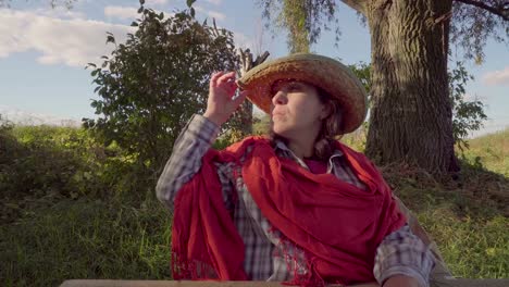 Woman-in-straw-hat-and-shawl-on-nature-background