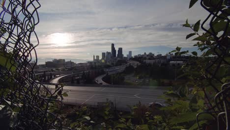 Vista-del-Skyline-de-ciudad-a-través-del-agujero-en-la-cerca-de-cadena