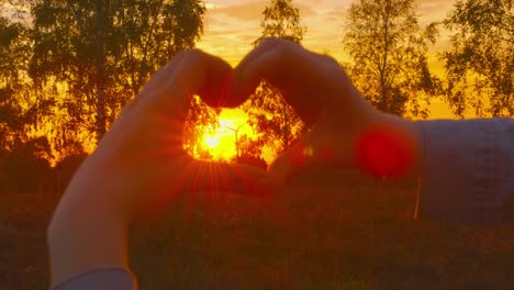 Pro-Wind-Power,-Pro-Nature---Beautiful-young-woman-forming-a-heart-shape-with-her-hands