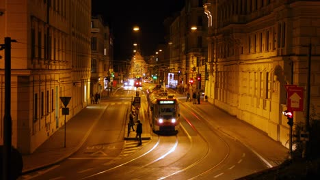 Timelapse-tram-stop-Silingrovo-city-square-in-Brno-passing-through-public-transport-during-the-night-long-street