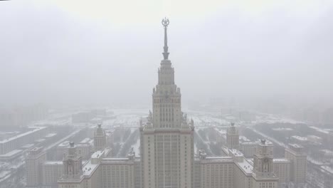 Aerial-footage-of-Moscow-State-University-in-winter-cloudy-and-snowy-weather