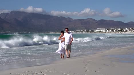 Romantic-couple-walking-along-beach,-Cape-Town,-South-Africa