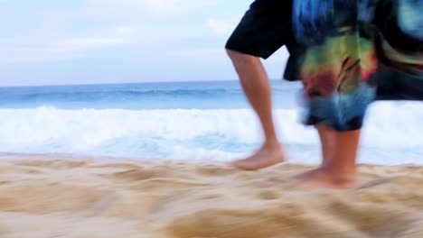 Close-up-of-the-feet-of-an-older-couple-walking-down-the-beach