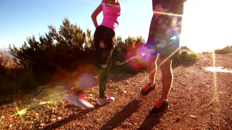 Young-afro-american-couple-warming-up-before-running-outdoors