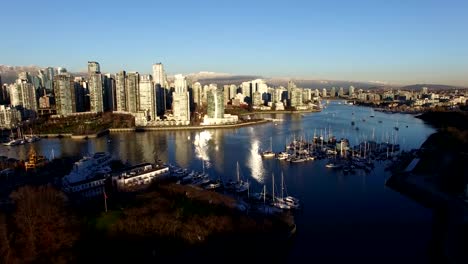 aerial-towards-downtown-and-snowcapped-mountains