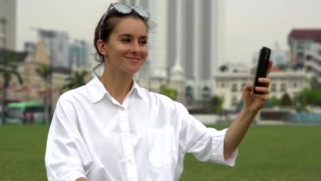 Tourist-take-photos-and-selfies-on-grass-in-Kuala-Lumpur