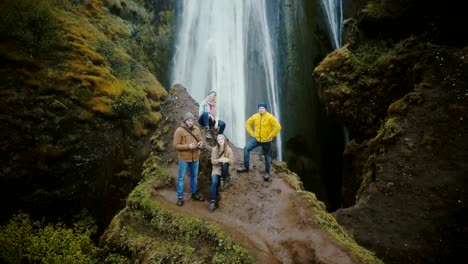 Aerial-view-of-the-tourists-in-Gljufrabui-waterfall-in-Iceland.-Copter-moving-away-from-friends,-selfie-on-drone