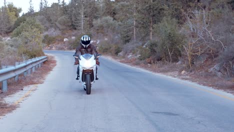 Man-riding-on-a-white-sports-motorcycle