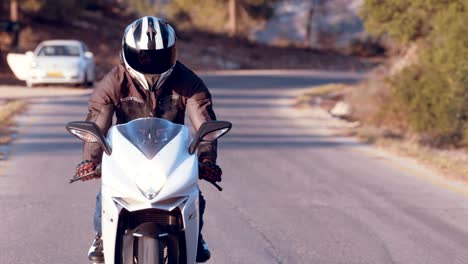 Man-riding-on-a-white-sports-motorcycle