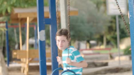 Children-swinging-together-at-a-public-playground