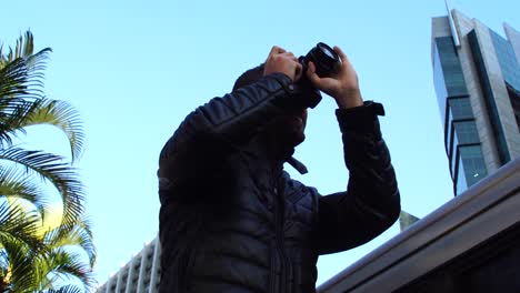 Man-photographing-the-Avenida-Paulista,-Sao-Paulo,-Brazil