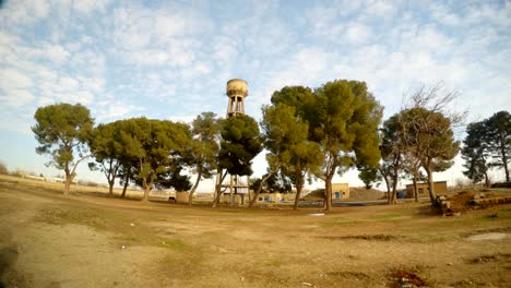 un-pequeño-bosque-de-árboles-y-una-torre-de-agua,-cerca-de-la-frontera-entre-Turquía-y-Siria