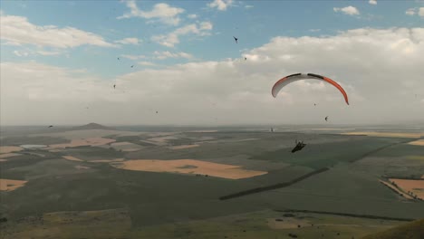 Athlete-paraglider-flies-on-his-paraglider-next-to-the-swallows.-Follow-up-shooting-from-the-drone