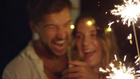 Laughing-Couple-Kissing-when-Holding-Sparkler