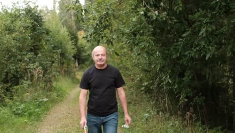 Mature-caucasian-man-playing-badminton-outdoor.