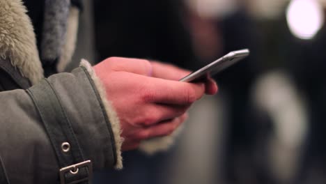 Close-up-of-hands-holding-cellphone-device-checking-emails