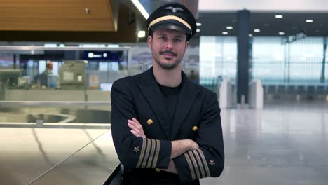 Young-airplane-captain-standing-on-airport