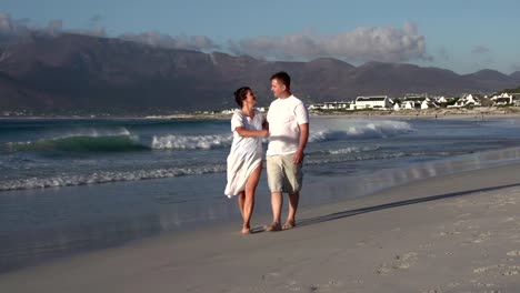 Romantic-couple-walking-along-beach,-Cape-Town,-South-Africa