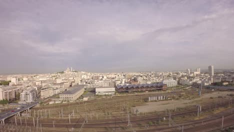 Paris,-10th-arrondissement---Aerial-view-of-Paris-with-Gare-du-nord-railway-in-foreground-and-tilt-up-of-city-skyline