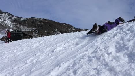 little-girl-slide-on-snow-during-winter-holiday