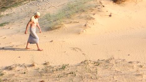 A-man-walks-through-the-desert