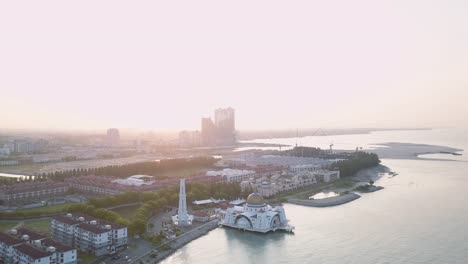 Aerial-Footage---Sunrise-at-a-mosque,-The-Melaka-Straits-Mosque