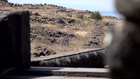 Peering-Through-Rubble-of-Ancient-Temple-at-Arid-Landscape