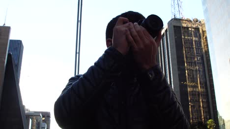 Man-photographing-the-Avenida-Paulista,-Sao-Paulo,-Brazil