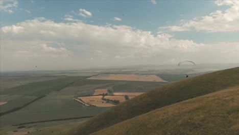 Athlete-paraglider-flies-on-his-paraglider-next-to-the-swallows.-Follow-up-shooting-from-the-drone