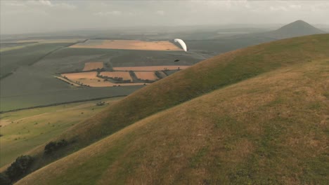 Athlete-paraglider-flies-on-his-paraglider-next-to-the-swallows.-Follow-up-shooting-from-the-drone