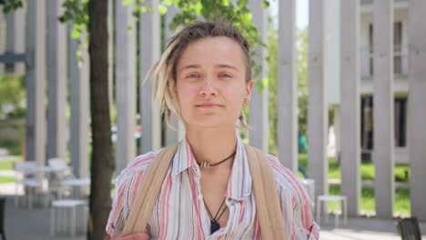 Young-Lady-with-Modern-Hairstyle-Smiling-Outdoors