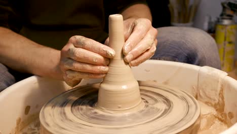 Man-works-with-a-potter's-wheel,-only-hands