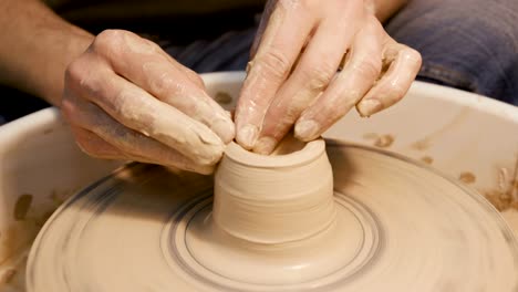 Man-works-with-a-potter's-wheel,-only-hands