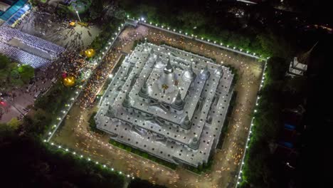 Aerial-time-lapse-view-over-big-pagoda-in-Asokaram-temple-in-Samutprakarn-near-Bangkok-Thailand-during-Asalha-Puja(Asanha-Bucha)Buddhist-festival-which-typically-takes-place-in-July,-on-the-full-moon.