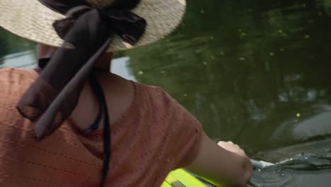 Young-girl-canoeing-on-a-beautiful-lake-with-close-up-on-paddle