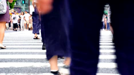 Legs-of-people-walking-on-the-crosswalk-in-Shibuya,-Tokyo-in-Japan.-4K