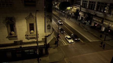 Two-People-Crossing-the-Street-at-Night,-Broadway-Trade-Center,-LA