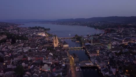 Crepúsculo-ilumina-zurich-ciudad-centro-Ribera-lago-vista-aérea-panorama-4k-Suiza