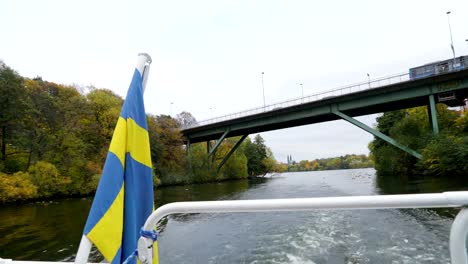 A-flag-of-Sweden-on-the-back-of-the-boat-in-Stockholm