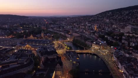 sunset-illuminated-zurich-city-center-riverside-aerial-panorama-4k-switzerland