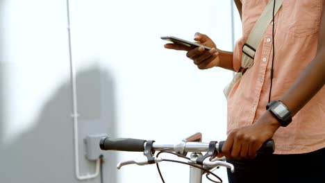 Woman-with-bicycle-using-mobile-phone-4k