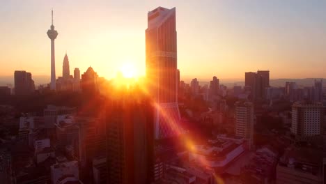 Aerial-view-of-Kuala-Lumpur-during-sunrise-with-the-sun-in-between-of-the-Kuala-Lumpur-City-Centre-building