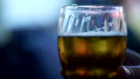 Beer-Glass-in-a-Pub.-Close-up-of-beer-glass-with-blur-background-stock-footage