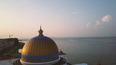 Aerial-Footage---Sunrise-at-a-mosque,-The-Melaka-Straits-Mosque